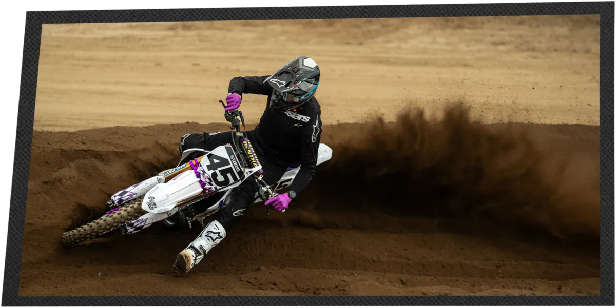 Jase laying the YZ250 over in a berm, roost up behind the rear wheel